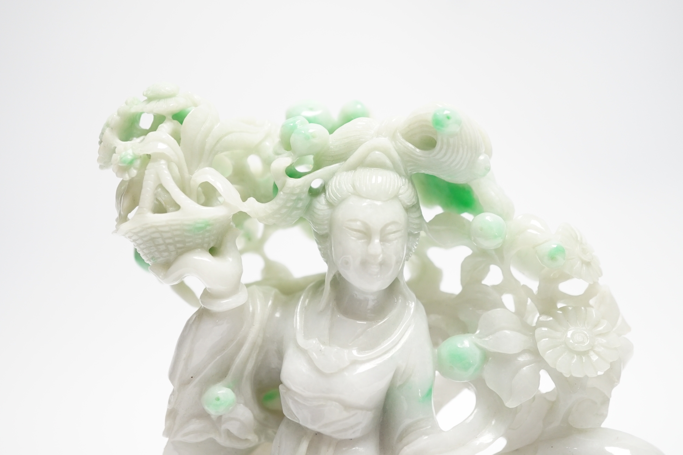 A Chinese jadeite figure of He Xiangu on carved stand, 17cm high